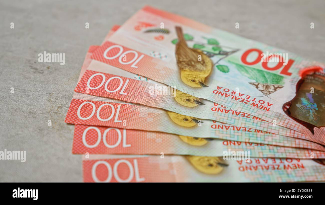New zealand dollars banknotes positioned on a concrete surface ...