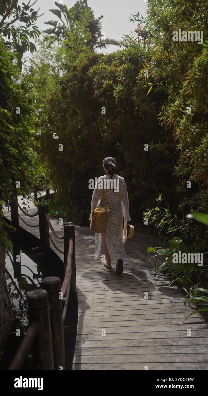 Resort woman walks along green hi-res stock photography and images - Alamy