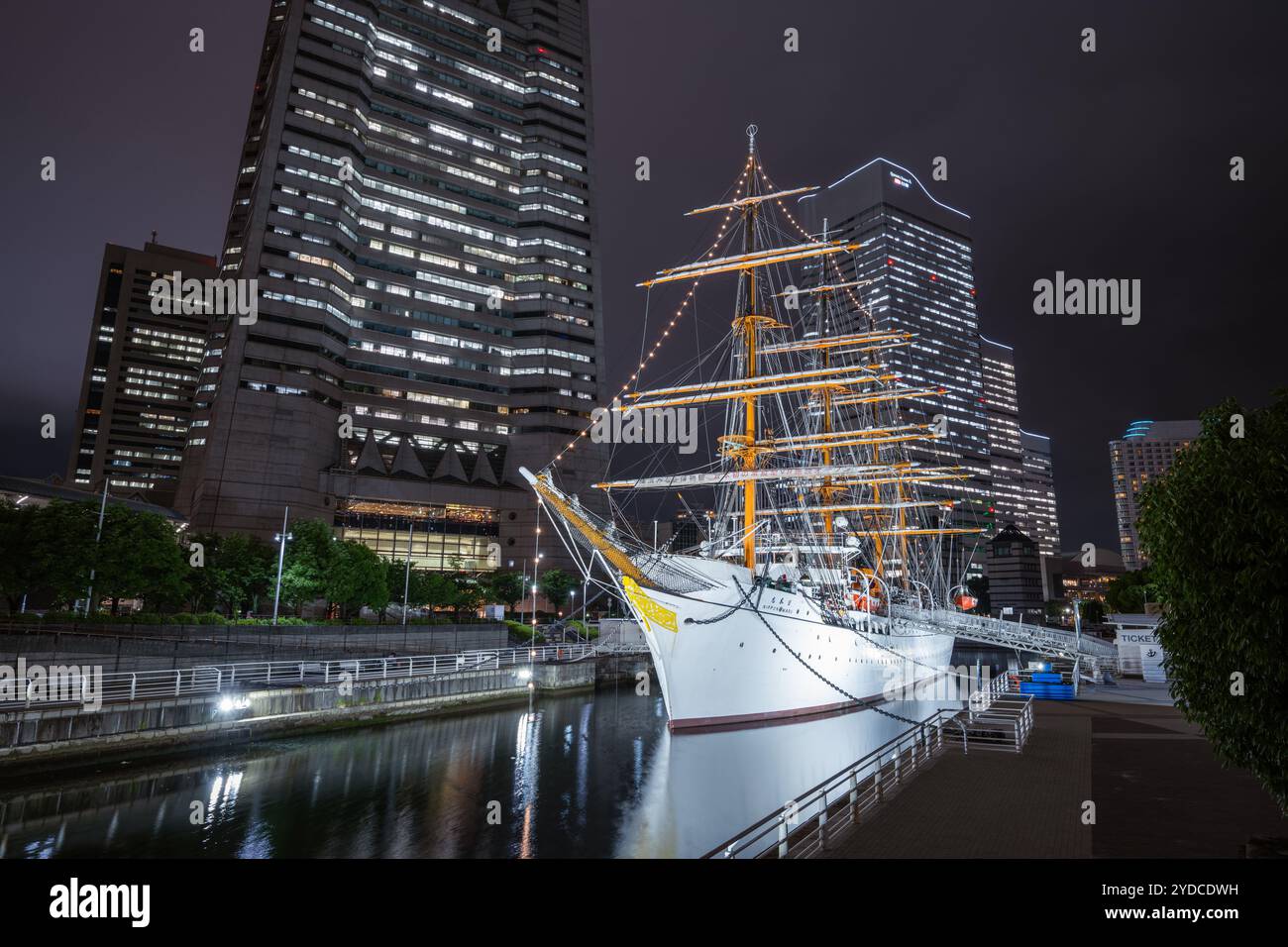 This is a night view of the Nippon Maru ship, a famous historic ship that is now docked in the Minato Mirari 21 business district on June 13, 2023 in Stock Photo