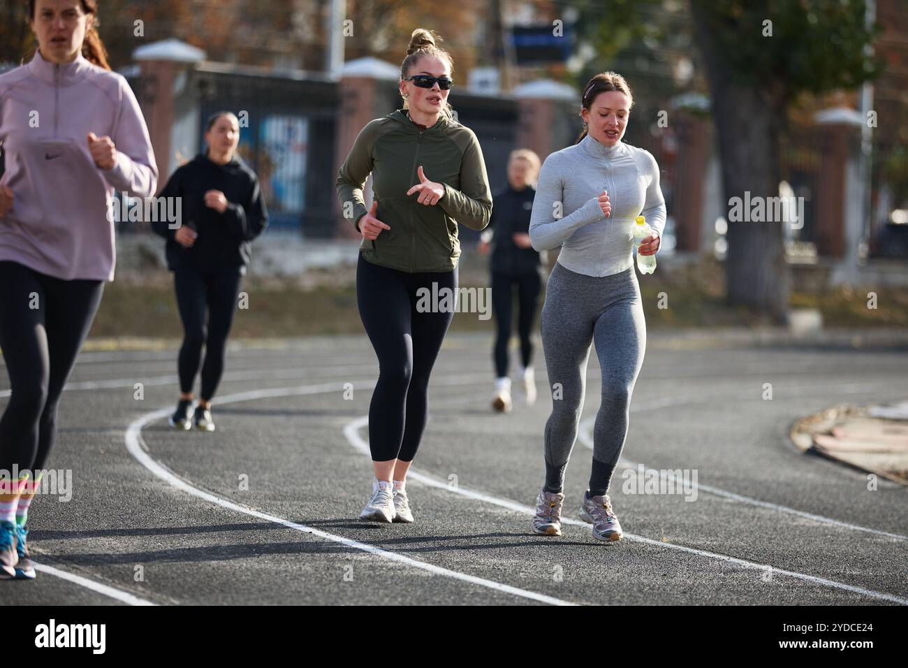 Group of women running together on a track. Amateur runners training ...