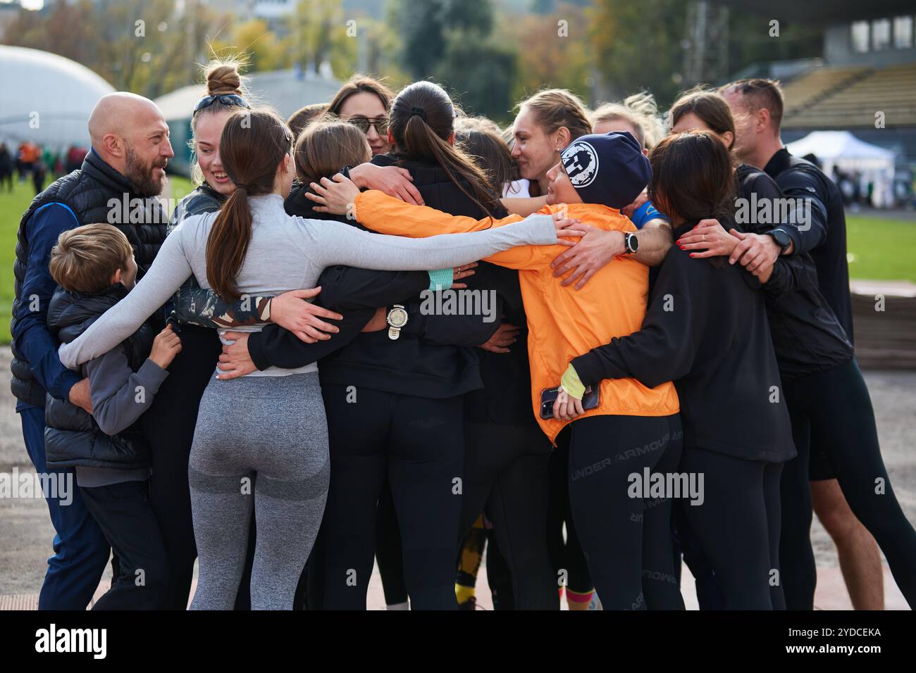 Group of athletes hug after training outdoors in Ukraine. Kyiv - 19 ...