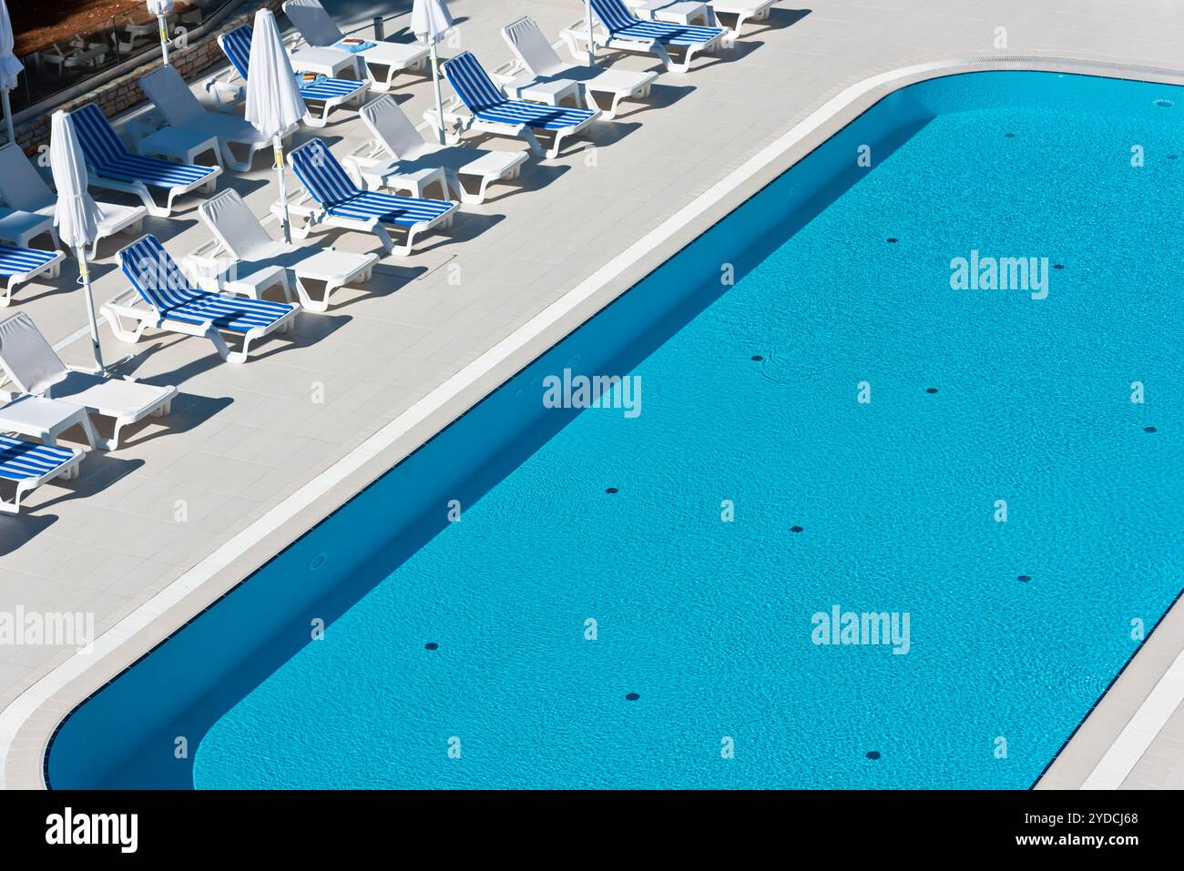 Hotel poolside chairs near a swimming pool stock photo alamy