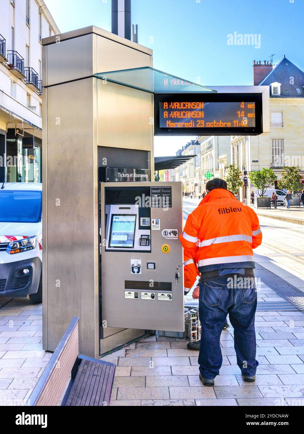 Worker in hi-viz jacket servicing an automatic ticket machine on the city tramway - Tours, Indre-et-Loire (37), France. Stock Photo