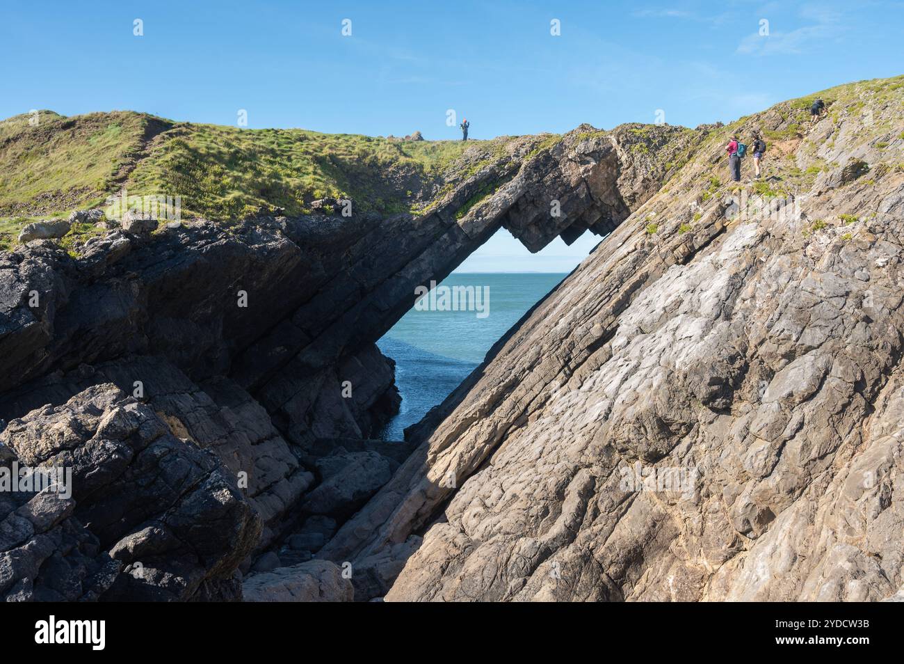 Peole Crossing Devils Bridge Worl s Head Gower Wales UK Stock Photo peole-crossing-devils-bridge-worl-s-head-gower-wales-uk-stock-photo