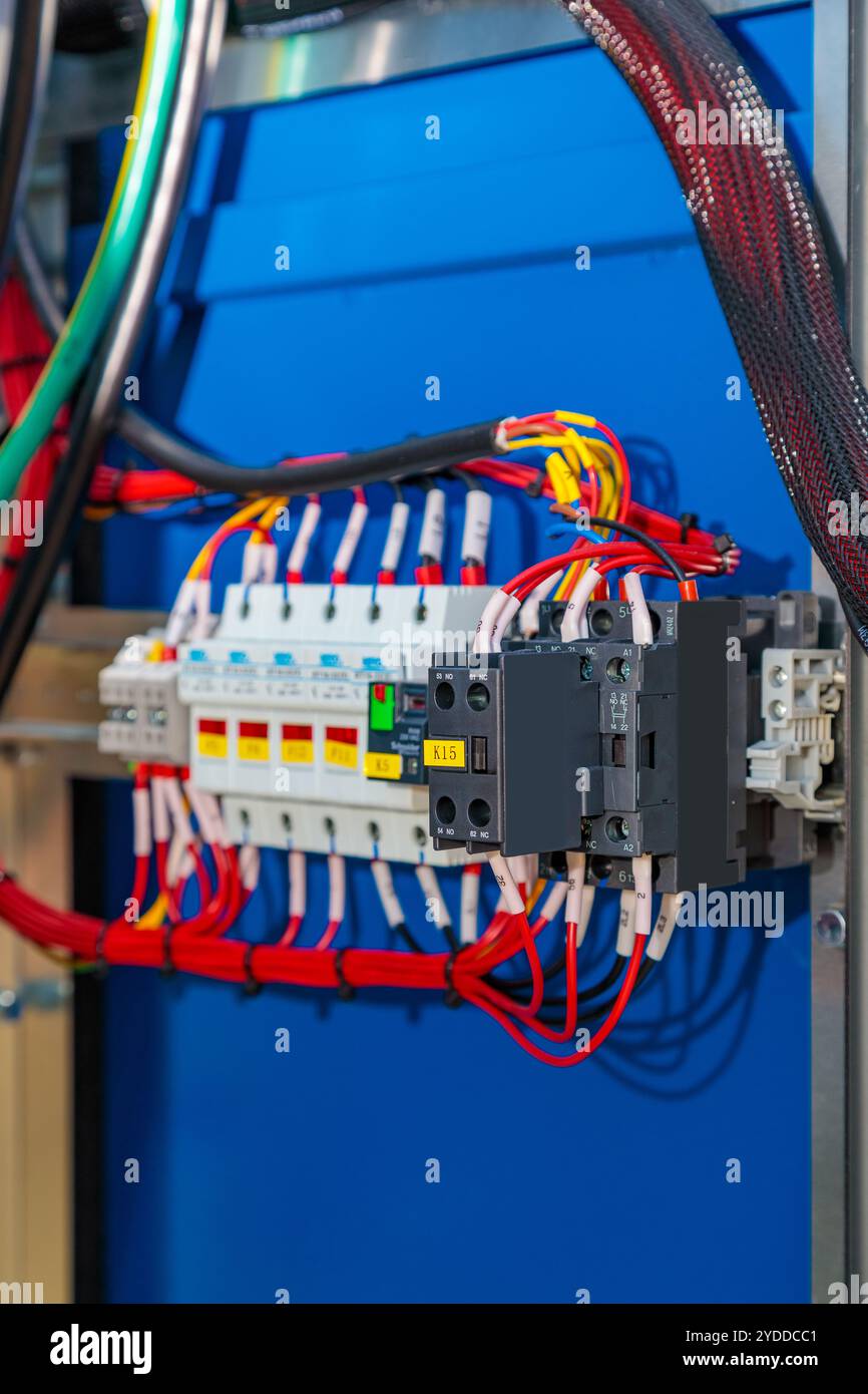 Close-up of an electrical cabinet highlighting fuses, wires, and