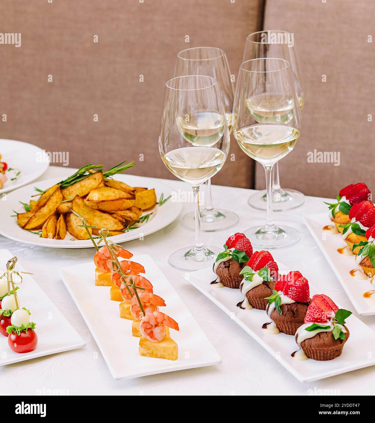 Table with different gourmet snacks for white wine Stock Photo