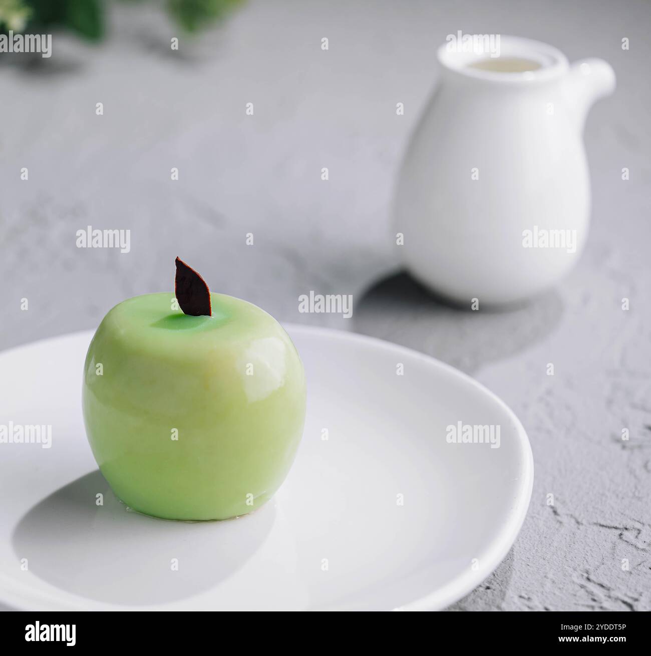 Apple shaped mousse cake and tea Stock Photo