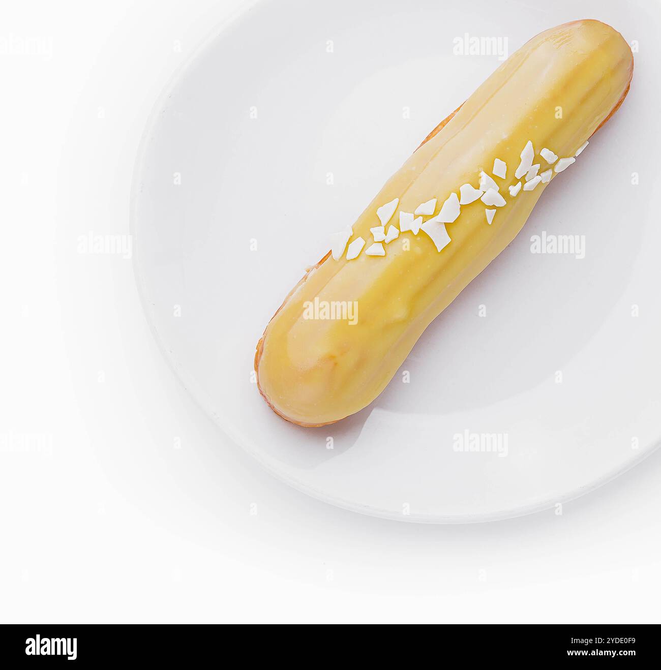 Delicious eclair with custard on plate top view Stock Photo