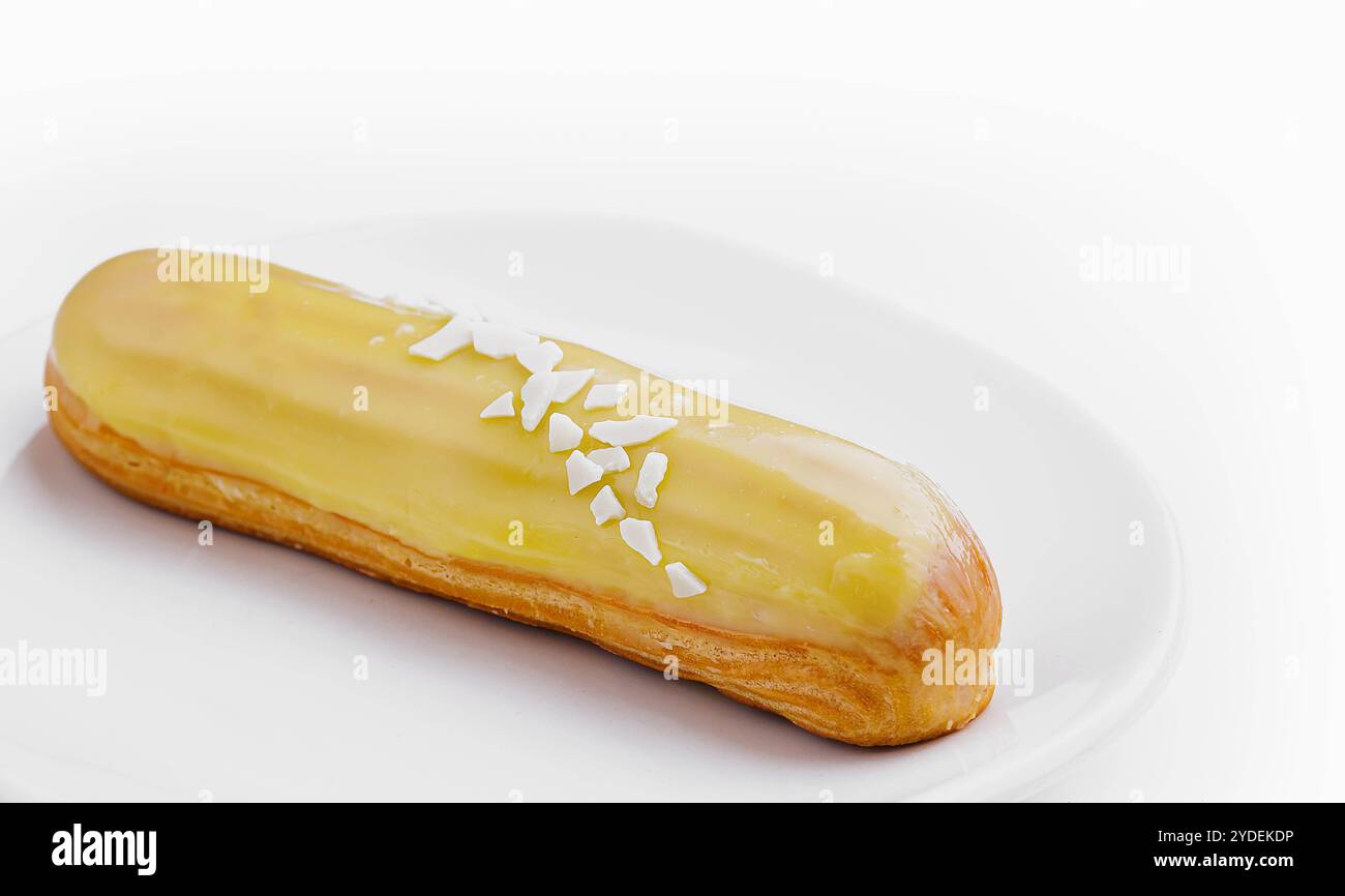 Delicious eclair with custard on plate top view Stock Photo