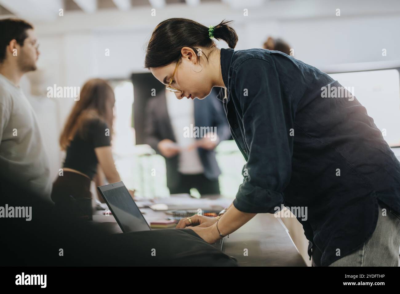 Students collaborating on school projects in a classroom setting Stock Photo