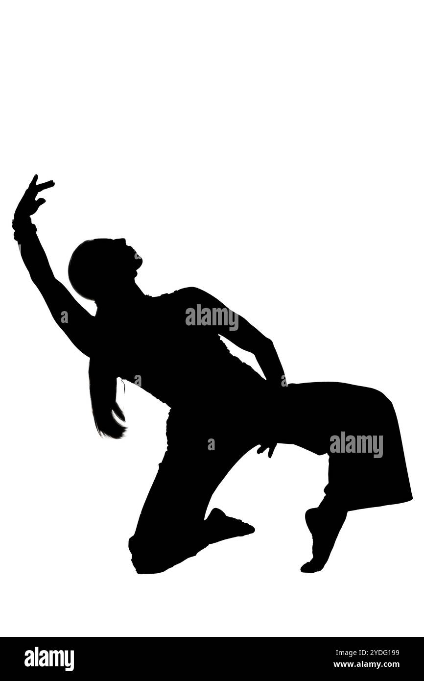 A person kneeling with arms outstretched in silhouette Stock Photo - Alamy