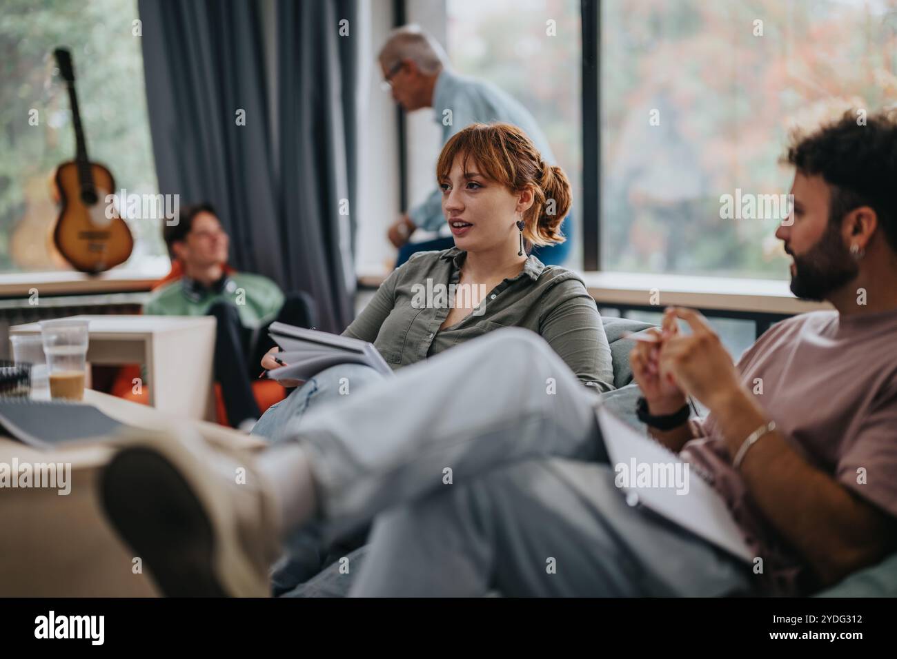 Professor engaging with students in a relaxed classroom setting Stock Photo
