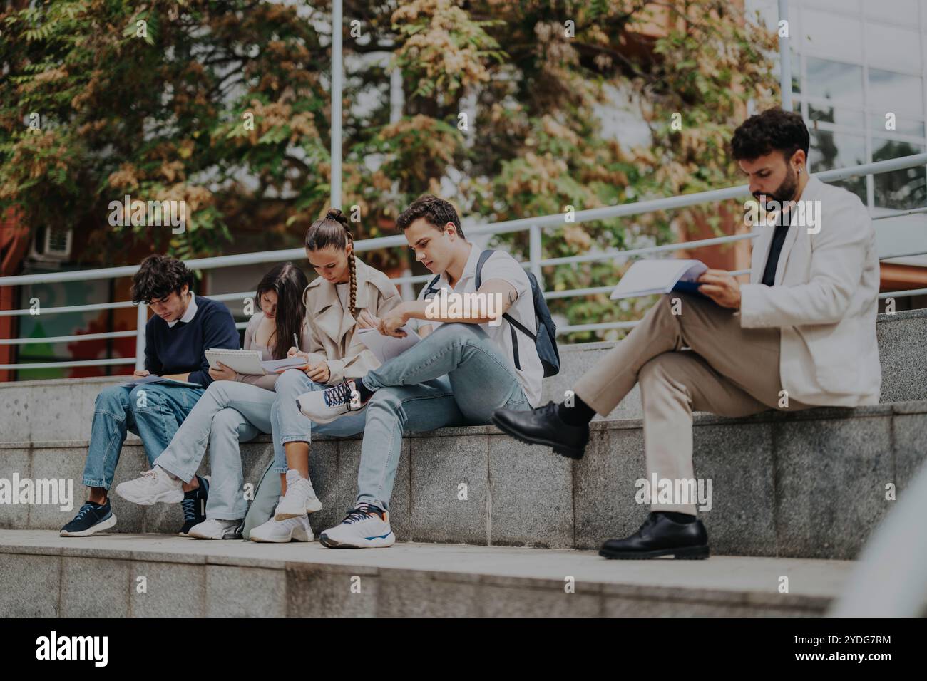 High school students learning outdoors with guidance from professor Stock Photo