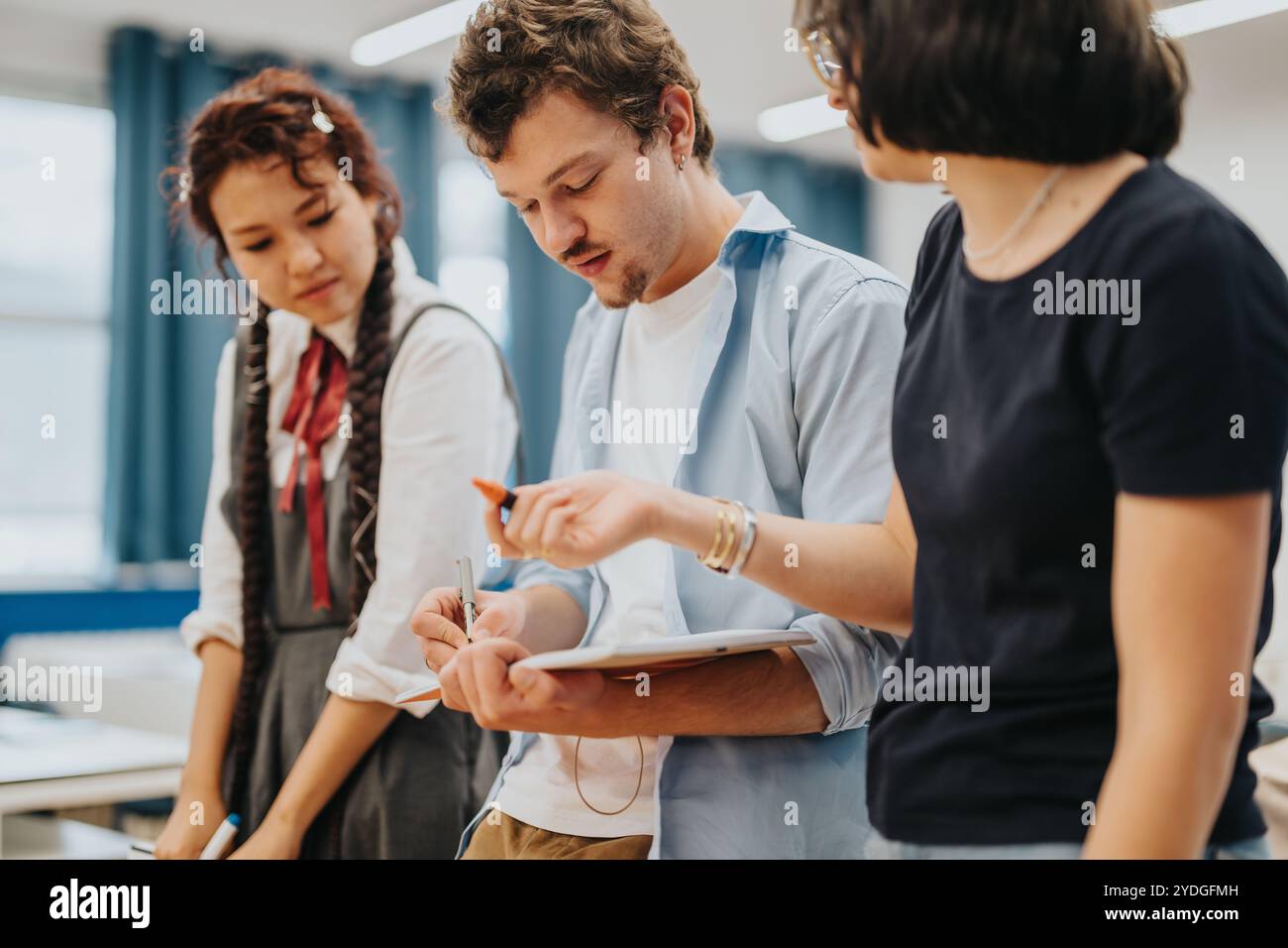 Group of students collaborating on a school project together Stock ...