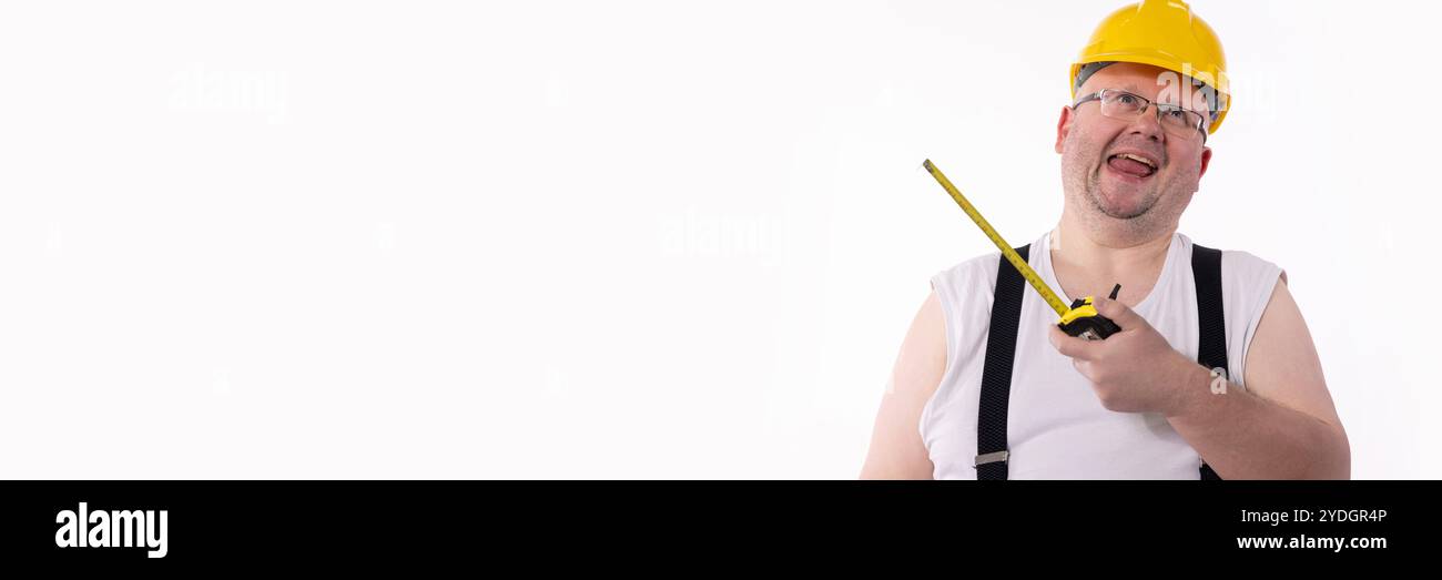 A Cheerful Construction Worker holding a Measuring Tape, illustrating joy in their craft Stock Photo