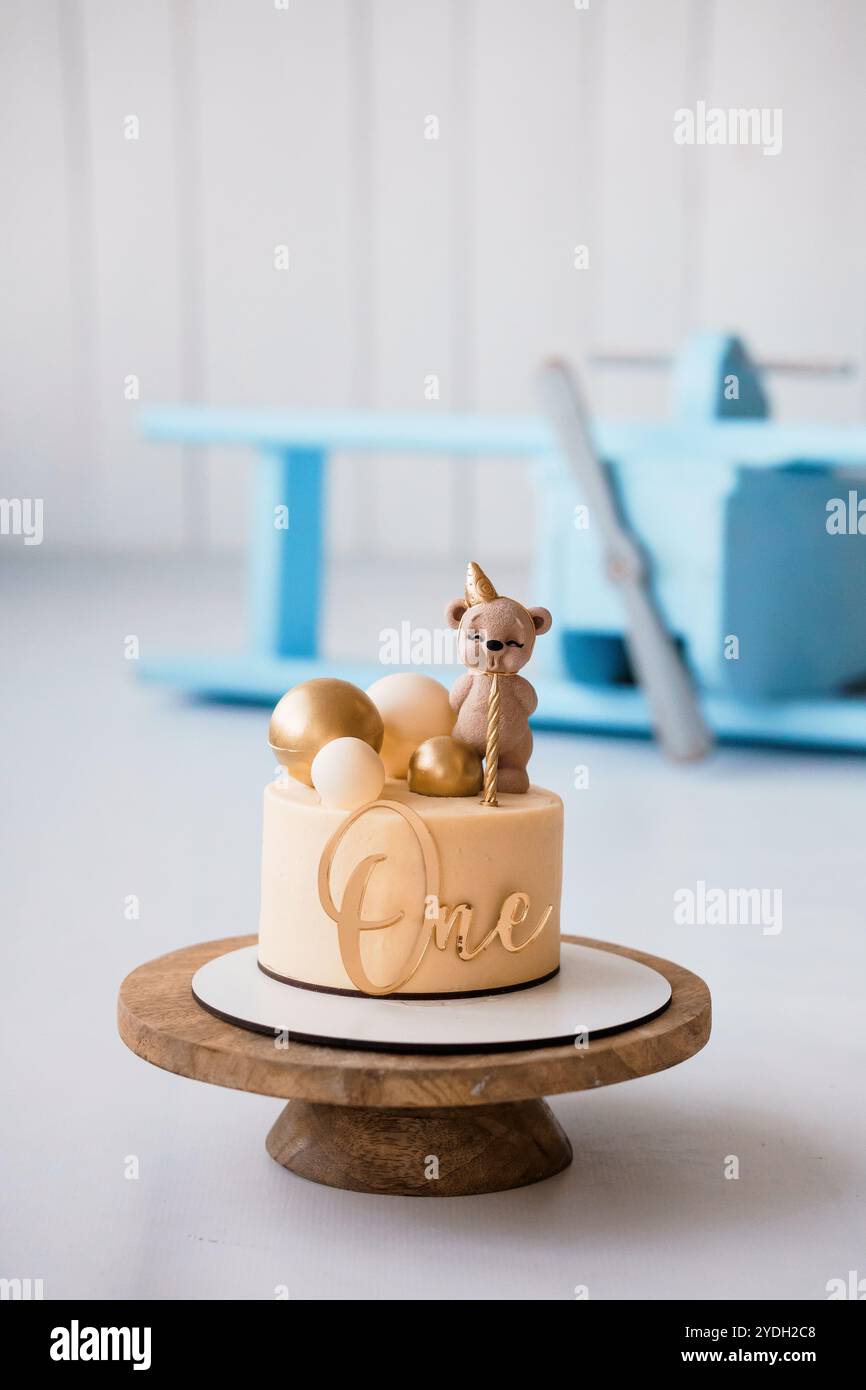 Delightful One-Year-Old Birthday Cake with Teddy Bear and Gold Accents ...