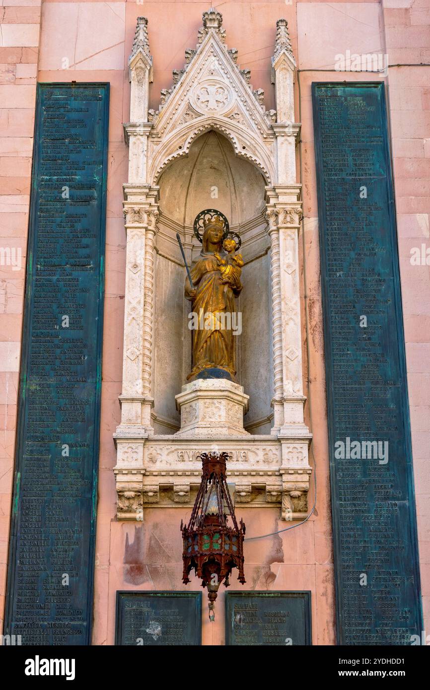 War memorial on the walls of the Cathedral of San Feliciano, Foligno, Italy, featuring bronze plaques listing the names of fallen soldiers and a centr Stock Photo