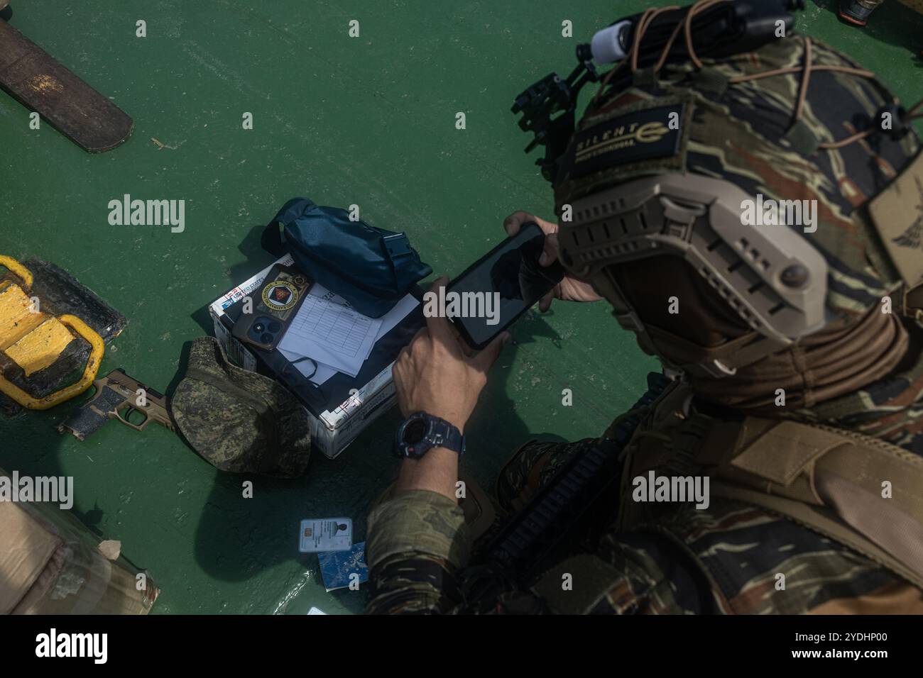 An Armed Forces of the Philippines (AFP) service member takes photos of ...