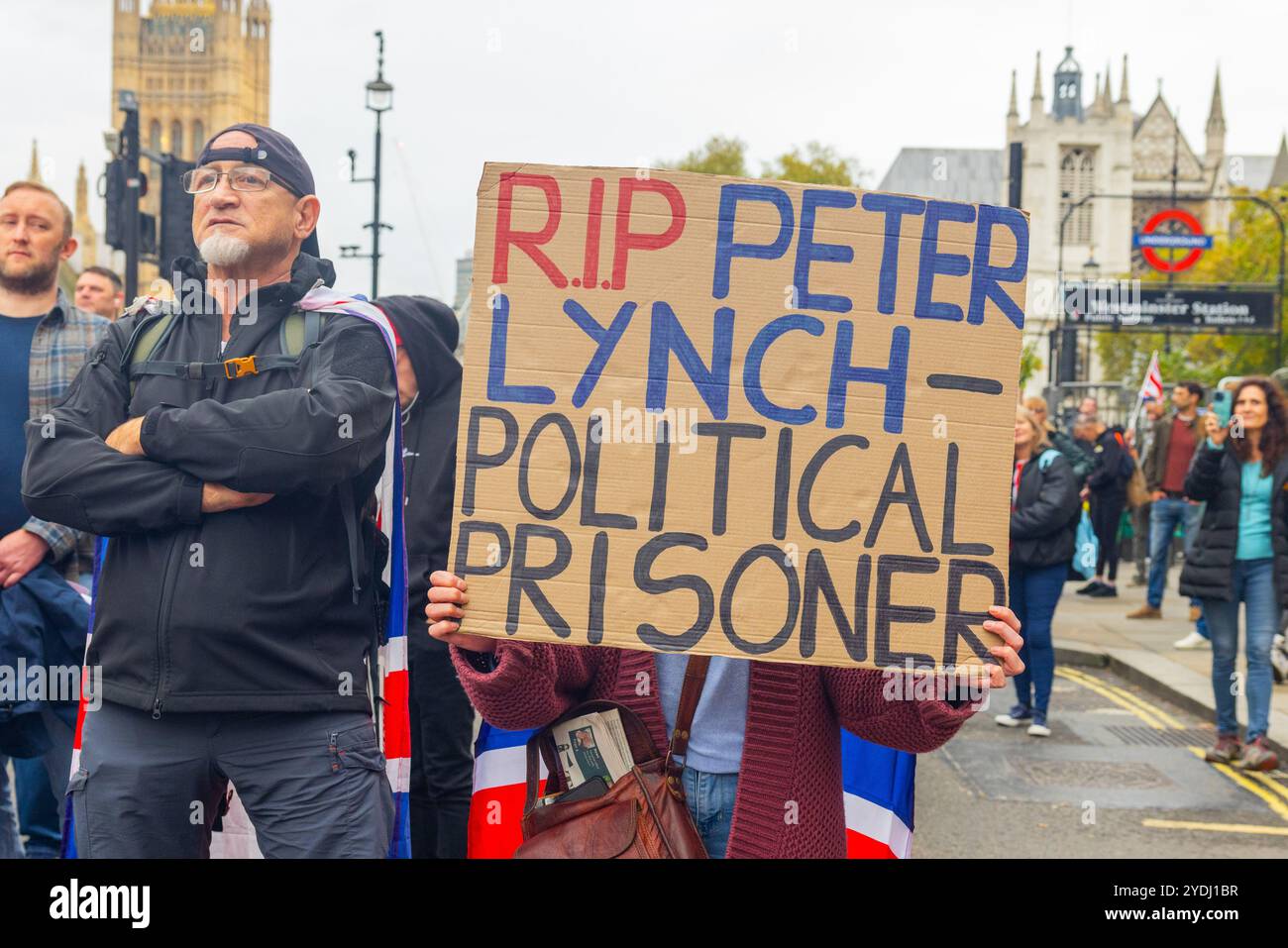 London, UK. 26 OCT, 2024. Sign commemorating Peter lynch, a man who attended the Rotherham riots, who died in prison, as thousands gathered for the Unite the Kingdom rally organised by Tommy Robinson, who was not in attendance due to being held in jail, gathering in Victoria the march peacefully made its way to Parliment square where a new documentary 'Lawfare' was screened. Stand Up to Racism mobilised a counter protest also with thousands of people, which peacefully gathered at the other end of whitehall. Credit Milo Chandler/Alamy Live News Stock Photo