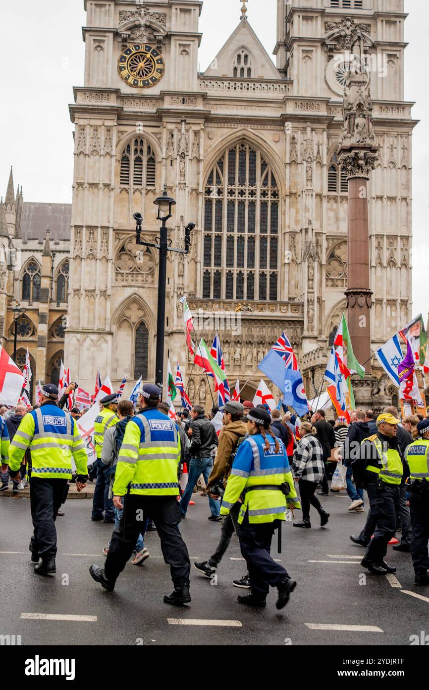 London, UK. 26th Oct, 2024. The Metropolitan Police stand guard during the demonstration. The Far Right descended on Central London despite their leader Tommy Robinson being absent due to being remanded by the Police. Fuelled by the recent suicide of Peter Lynch while in custody for violent disorder, the demonstration congregated outside Downing Street under the banner of ‘Uniting the Kingdom'. (Photo by Lab Ky Mo/SOPA Images/Sipa USA) Credit: Sipa USA/Alamy Live News Stock Photo