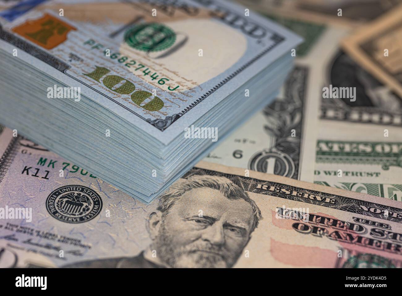 Pile of US 100 dollar banknotes on dollars background for design ...