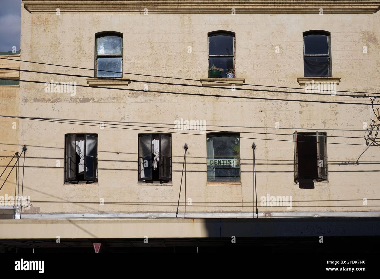 Windows and streetscape along Enmore Road, in inner city Sydney, white curtains and open casement windows, a facade of Victorian street architecture Stock Photo