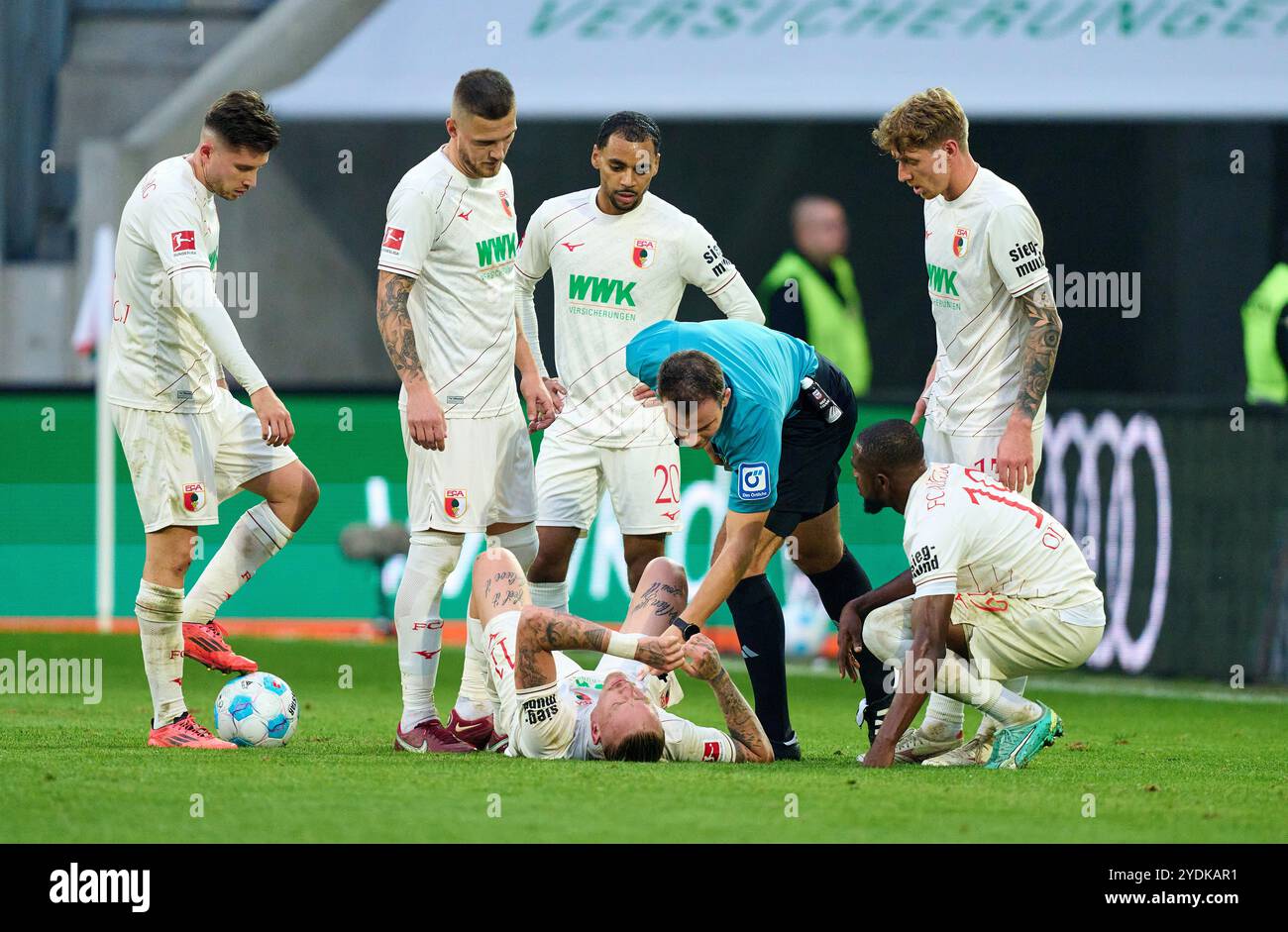 Marius Wolf, FCA 11  compete for the ball, tackling, duel, header, zweikampf, action, fight against Almugera Kabar, BVB 42 , referee Wolfgang Haslberger with whistle, gestures, shows, watch, individual action, Schiedsrichter, Hauptschiedsrichter, schiri, Pfeiffe, Pfiff,   in the match FC AUGSBURG - BORUSSIA DORTMUND 2-1  on Oct 26, 2024 in Augsburg, Germany. Season 2024/2025, 1.Bundesliga, FCA, BVB, matchday 8, 8.Spieltag Photographer: ddp images / star-images    - DFL REGULATIONS PROHIBIT ANY USE OF PHOTOGRAPHS as IMAGE SEQUENCES and/or QUASI-VIDEO - Stock Photo