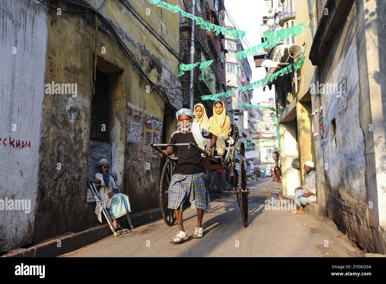 22.02.2011, Kolkata, West Bengal, India, A rickshaw driver takes two ...
