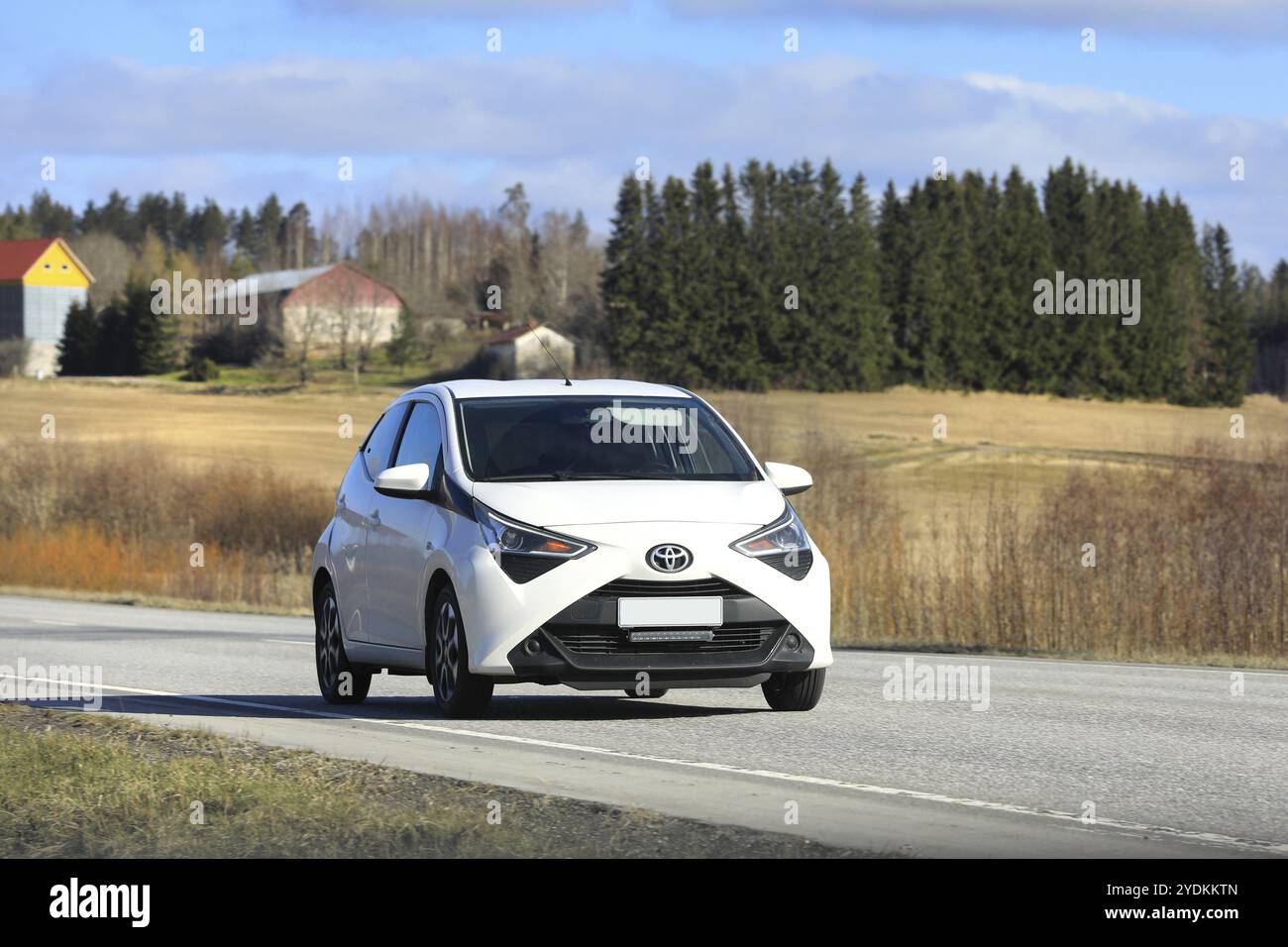 White Toyota Aygo city car, Second generation facelift model, at speed ...