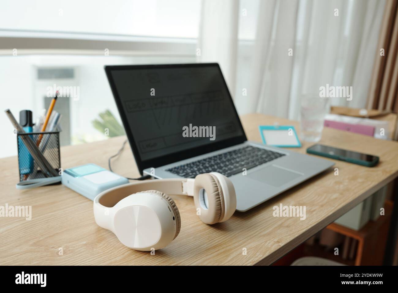 Modern Workspace Featuring Laptop and Headphones Stock Photo