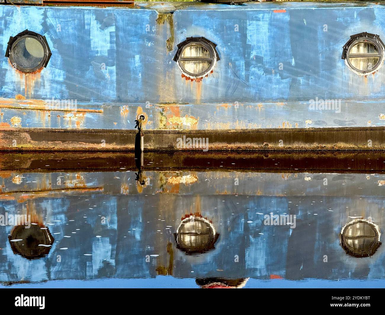 Reflections of narrow boat in canal on Leeds and Liverpool canal at Adlington near Chorley, Lancashire - Smartphone Captured Stock Image