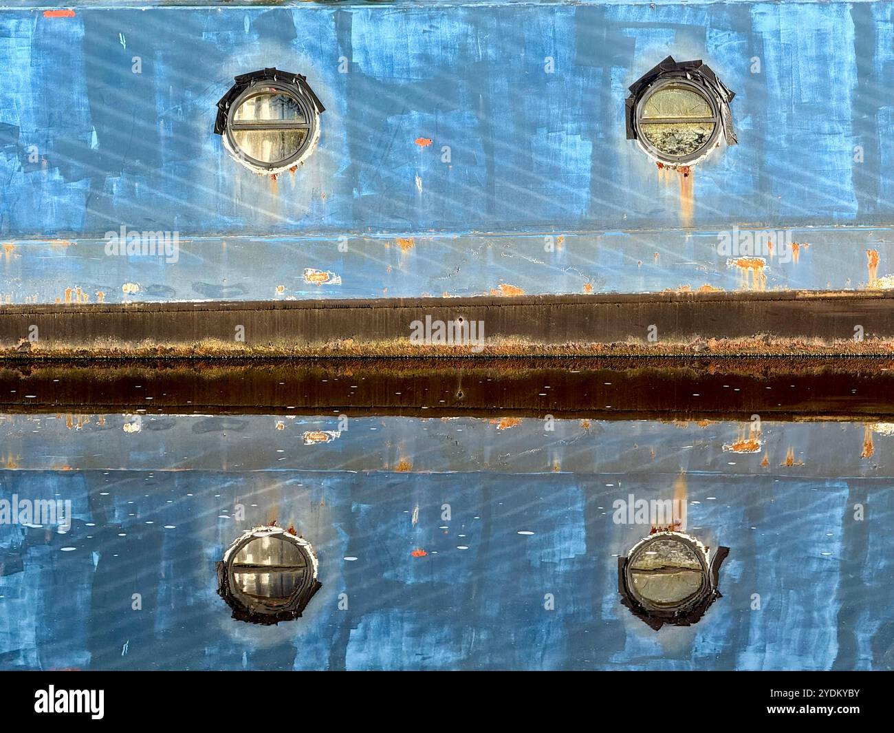Reflections of narrow boat in canal on Leeds and Liverpool canal at Adlington near Chorley, Lancashire - Smartphone Captured Stock Image