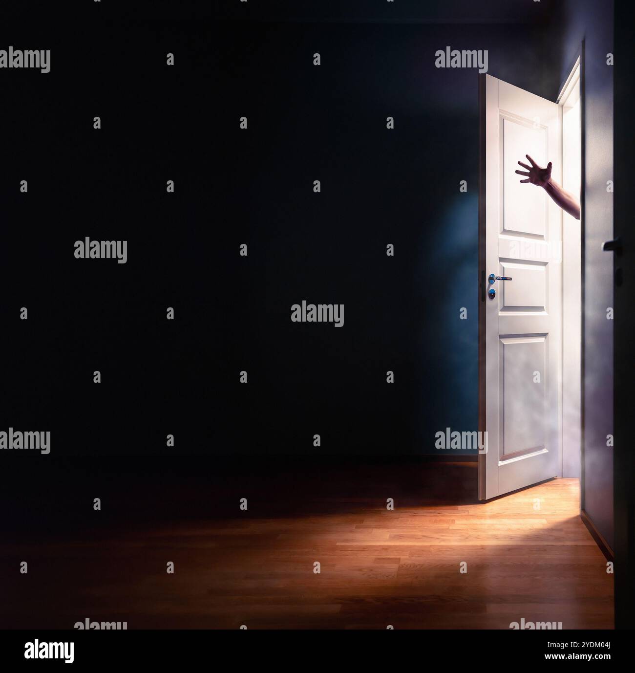 Horror door and hand. Scary halloween fantasy of a ghost or zombie or  in open closet. Spooky dark room in house. Creepy demon silhouette man. Stock Photo