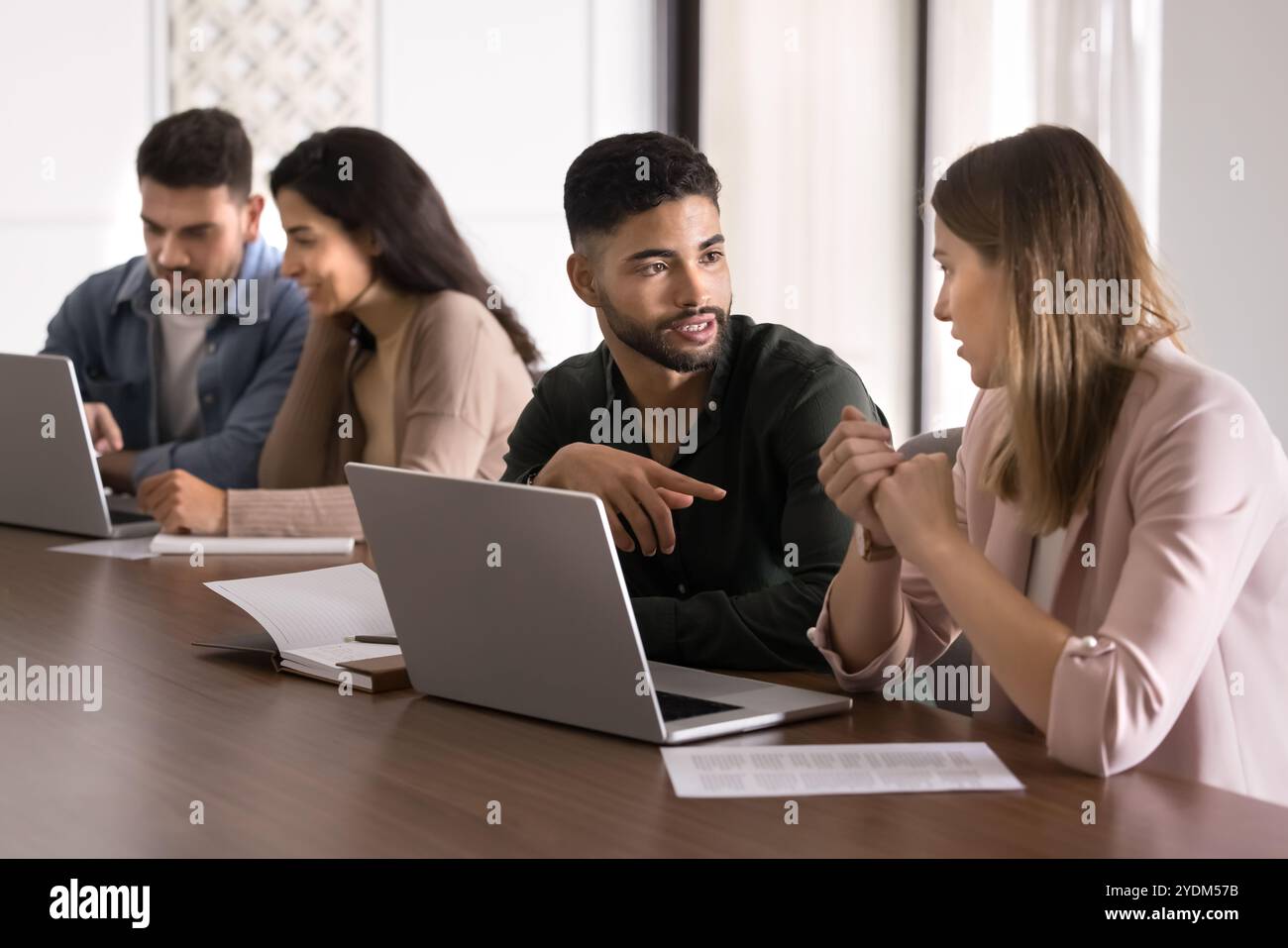 Serious young Arabic mentor training intern at laptop Stock Photo