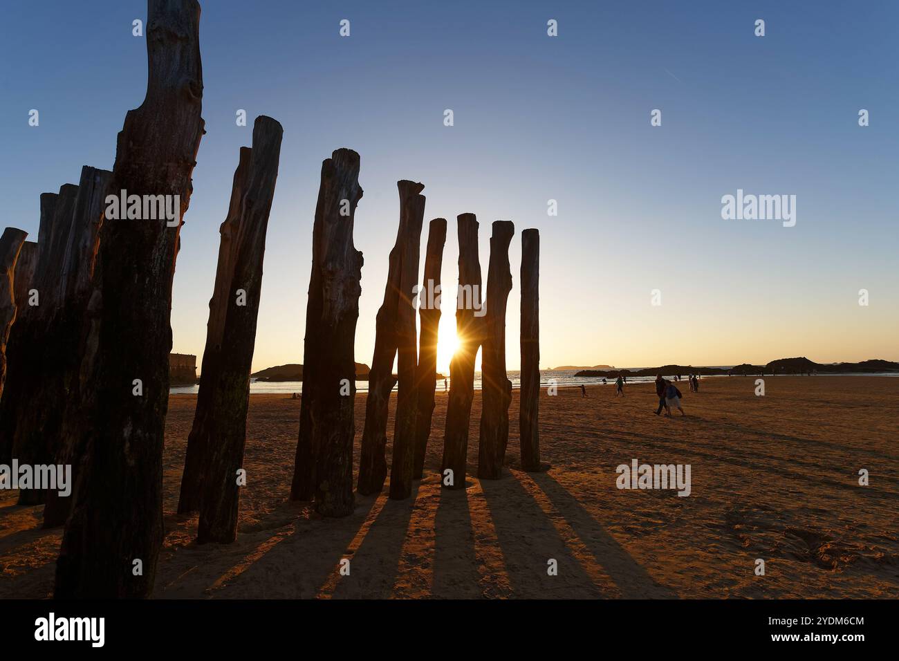 An idyllic beach scene featuring a picturesque view of a golden sunset in Saint-Malo . Stock Photo