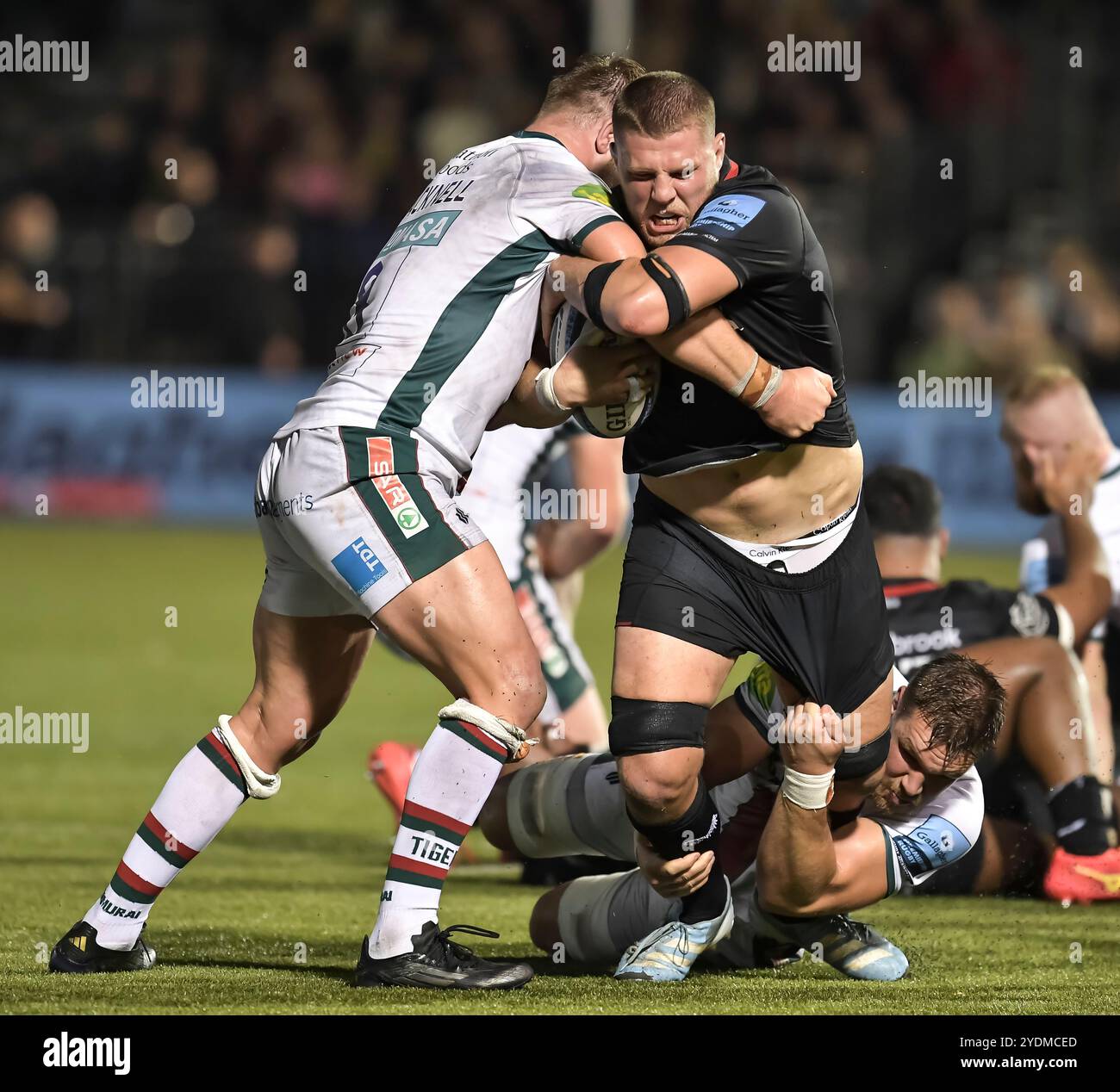 Olly Cracknell and Hanro Liebenberg of Leicester Tigers tackle Tom Willis of Saracens during the Gallagher Premiership Rugby match between Saracens and Leicester Tigers at StoneX Stadium on October 26, 2024 in Barnet, England. Photo by Gary Mitchell Stock Photo