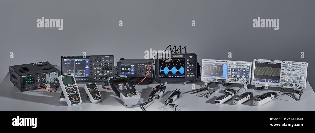 Various measuring devices and oscilloscopes set up on a work table in a ...