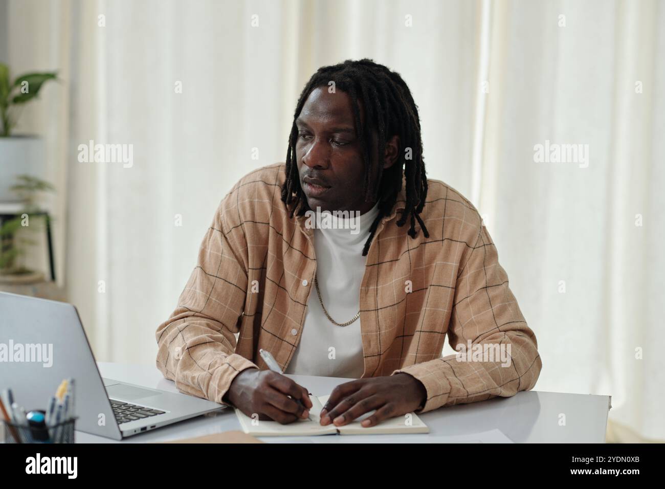 Contemplating Work at Modern Home Office Setting Stock Photo
