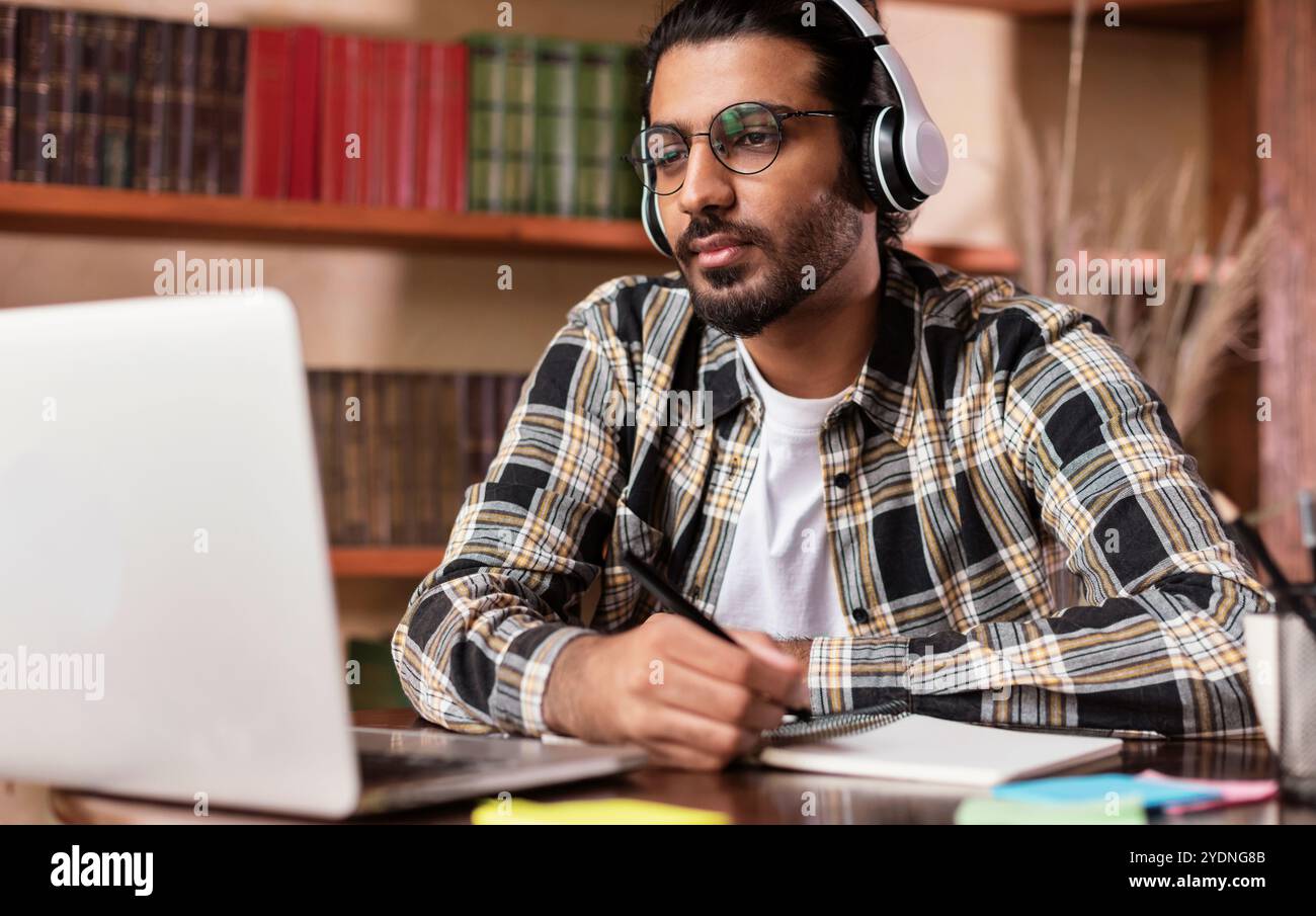 Arab Student Guy Learning Online At Laptop Sitting In Library Stock ...