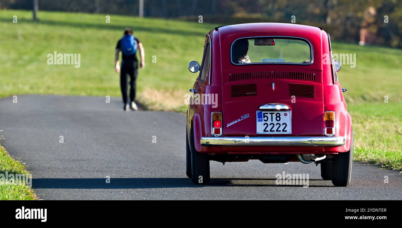 Vintage vehicle Fiat 500 from 60s in amazing condition on the road. Legendary tiny italian car. Stock Photo