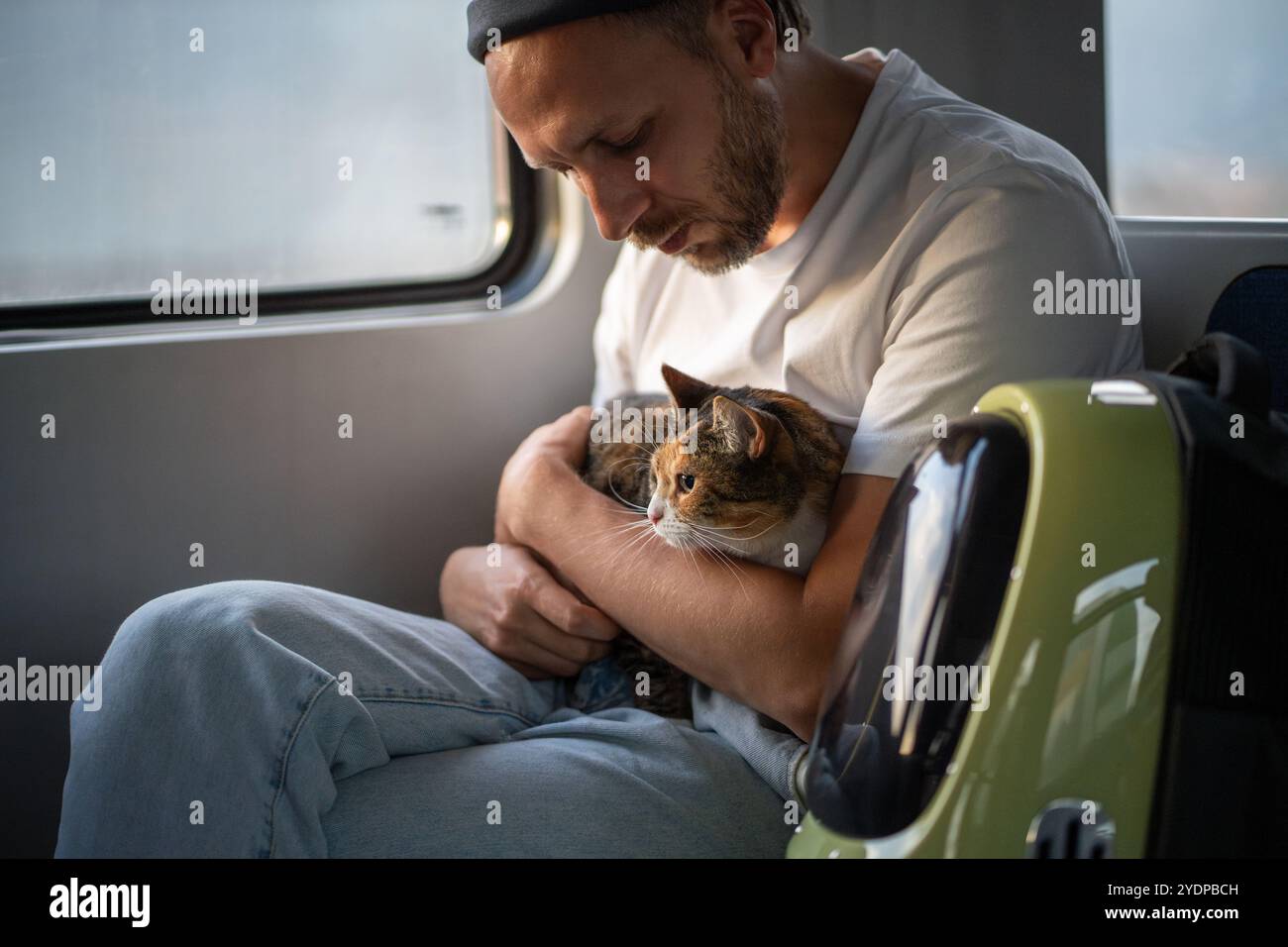 Public electric train ride of thoughtful man hugging calm peaceful ...
