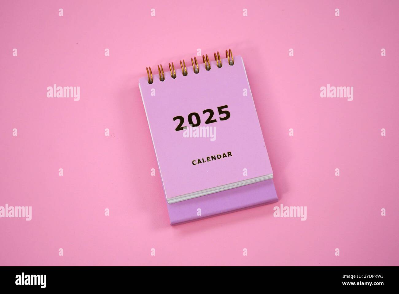 Pink desk calendar with gold 2025 calendar writing. New year 2025 ...