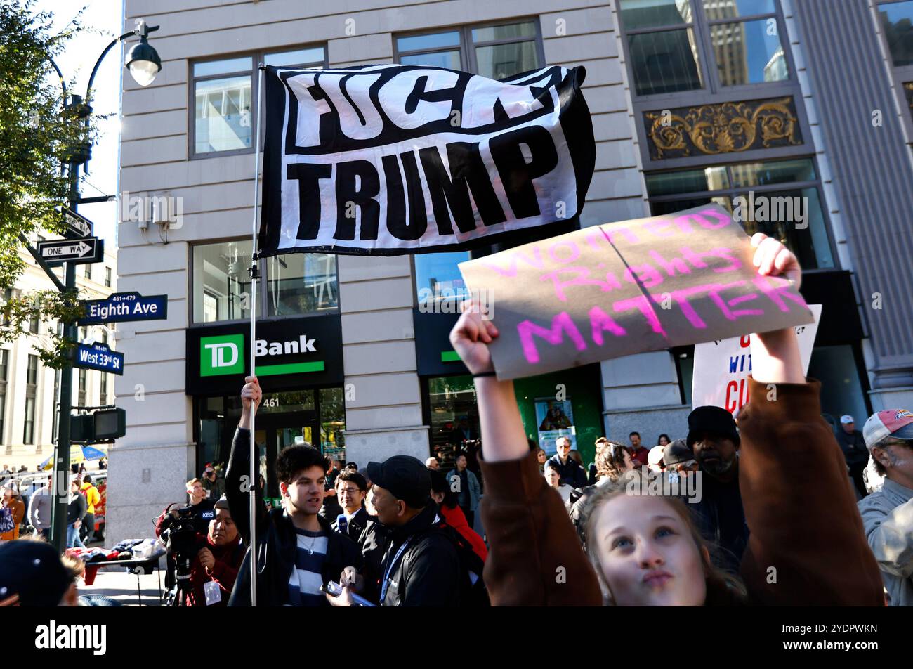 New York, United States. 27th Oct, 2024. Anti-Trump protesters wave ...