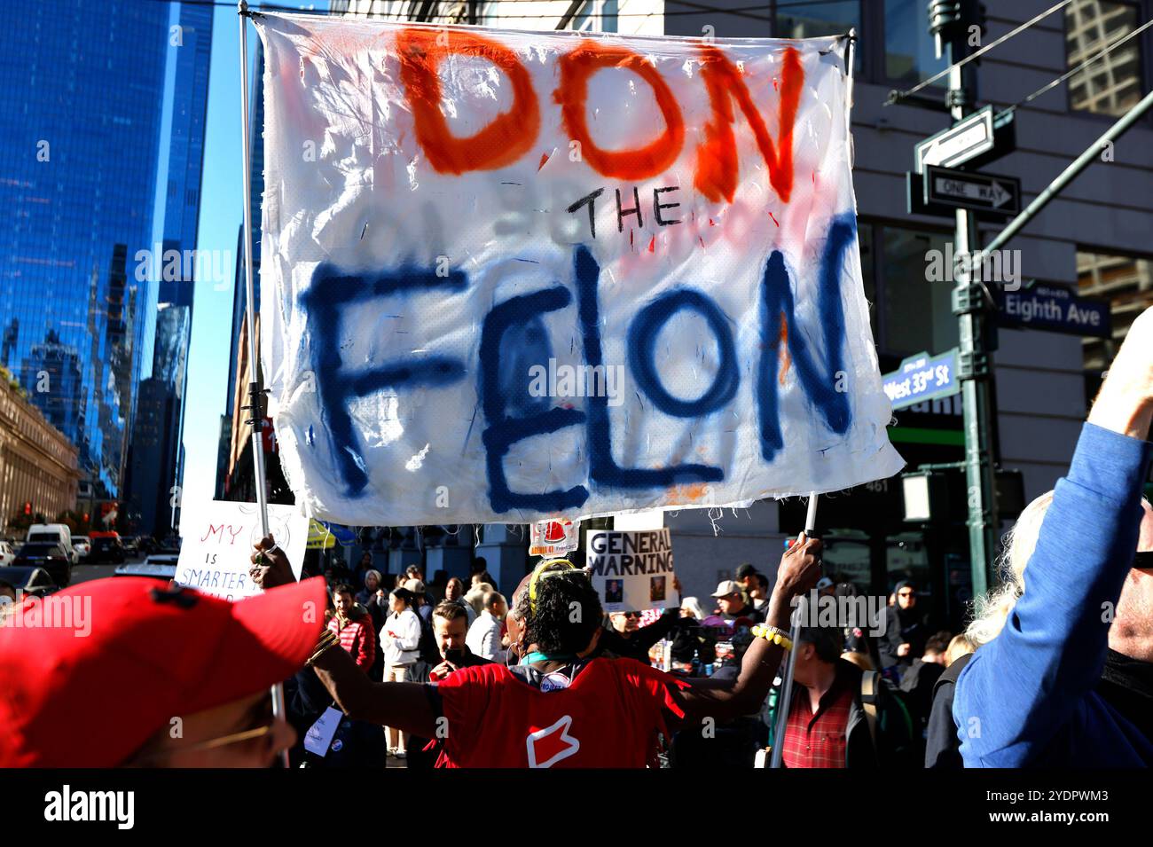 New York, United States. 27th Oct, 2024. Anti-Trump protesters wave ...