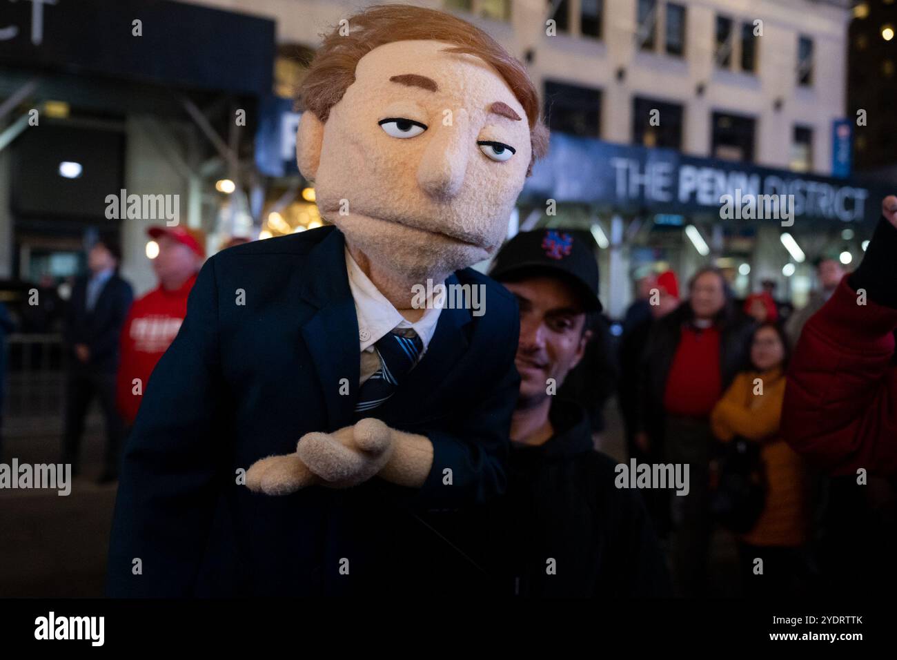 New York, USA. 27th Oct, 2024. A puppeteer with a Putin look-alike puppet entertains Trump supporters, who didn't have a ticket to Donald Trump's rally outside Madison Square Garden in New York, New York, on Oct. 27, 2024. (Photo by Gabriele Holtermann/Sipa USA) Credit: Sipa USA/Alamy Live News Stock Photo