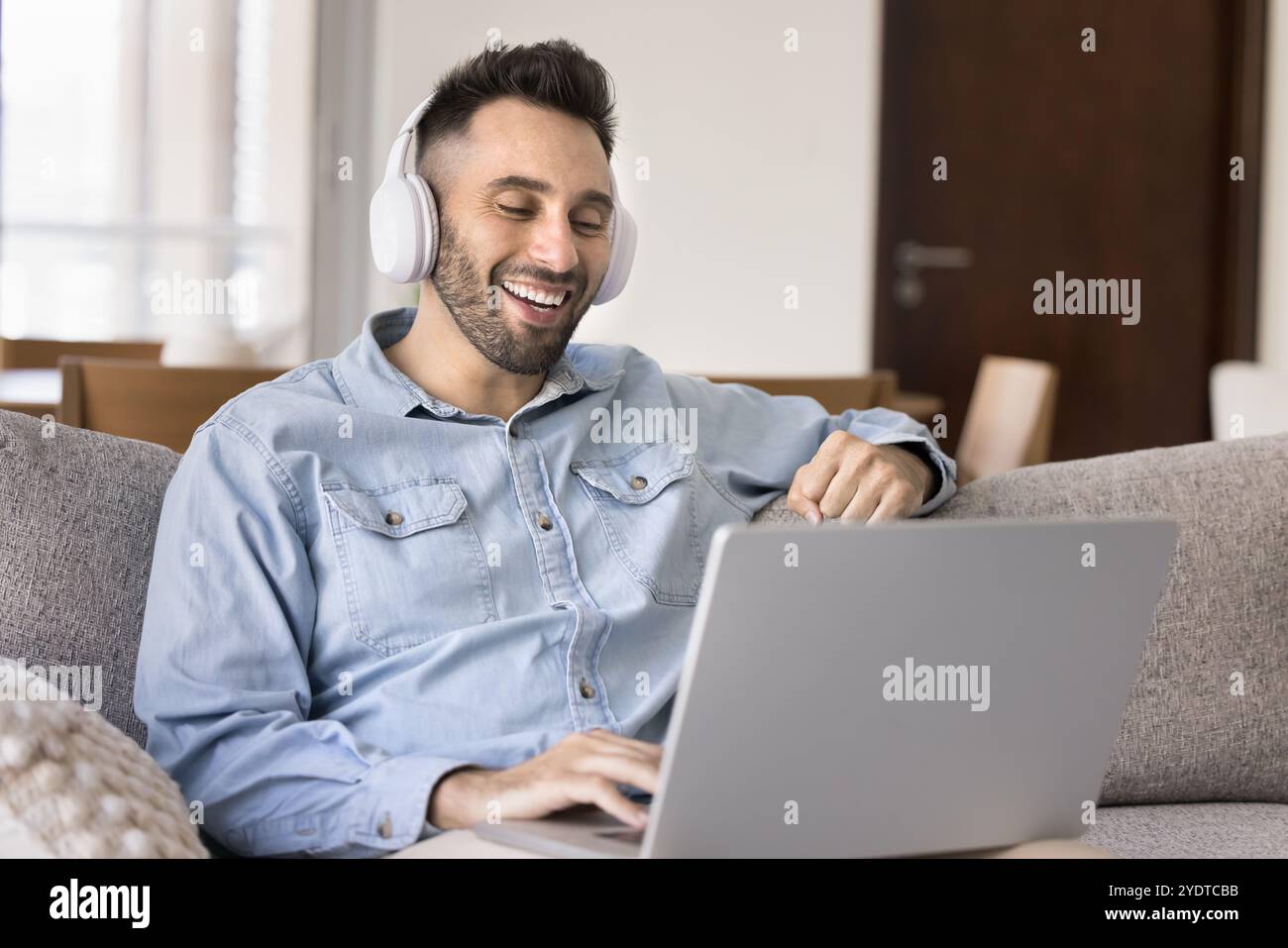 Cheerful young Hispanic man talking on video call Stock Photo