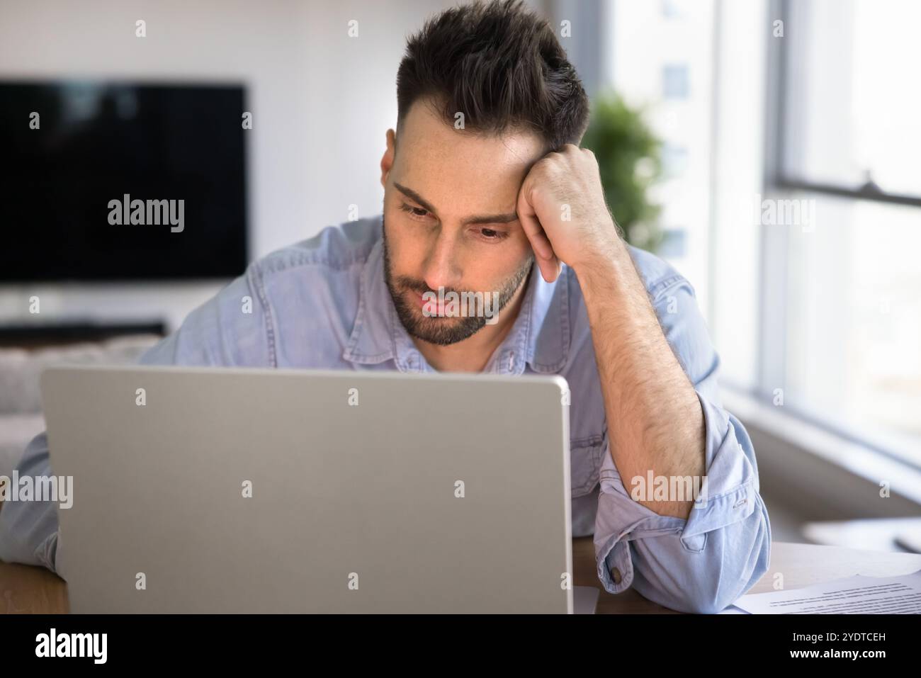 Tired Latin freelance entrepreneur man thinking on solutions for startup Stock Photo