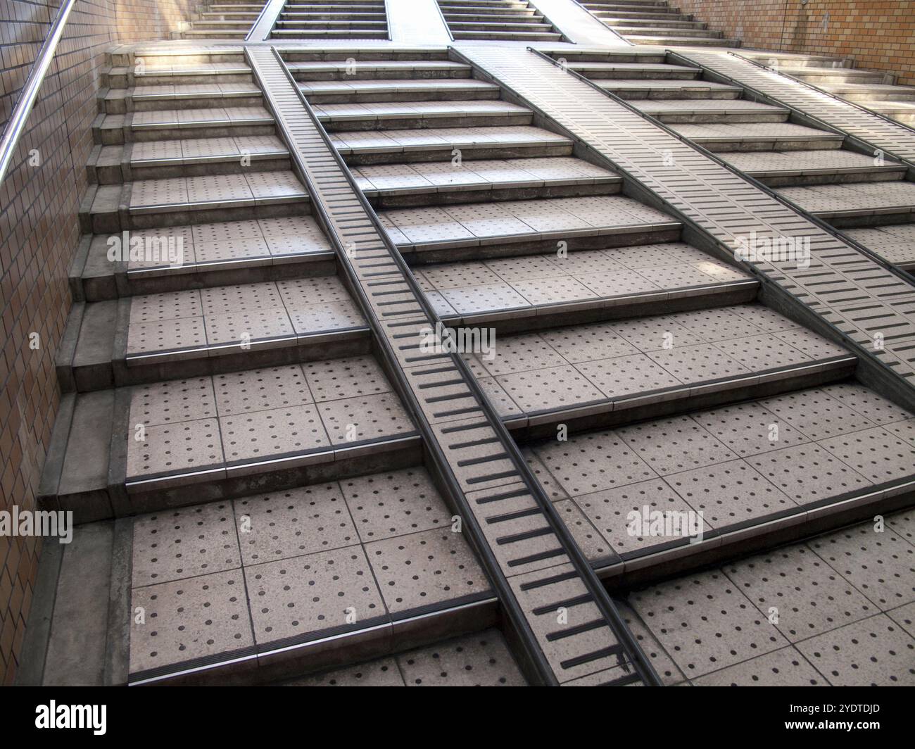 Staircase with ramp leading to underground passage Stock Photo - Alamy