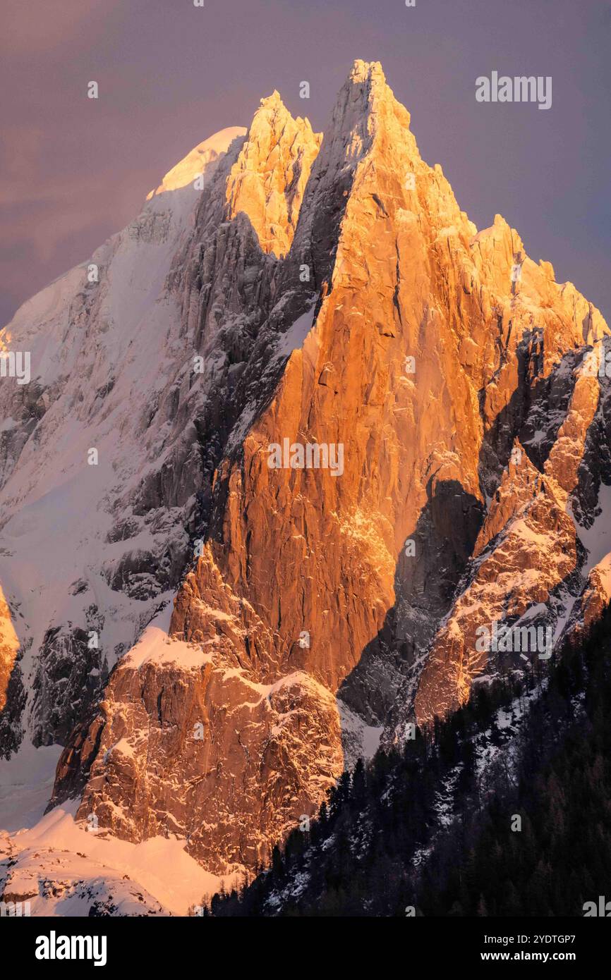 Wintery pink, sunset over Aiguilles du Drus in the French Alps. Stock Photo