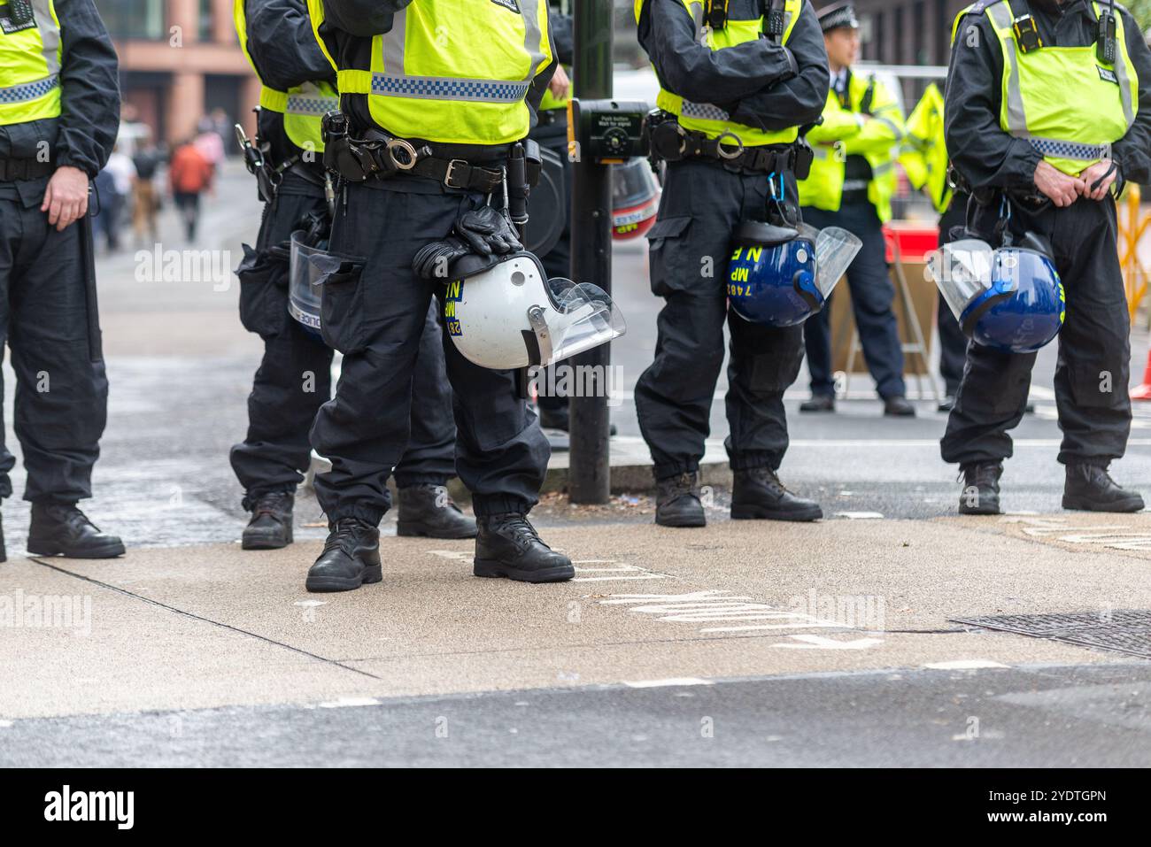 Supporters of Stephen Yaxley-Lennon (AKA Tommy Robinson) are taking part in a protest march to Whitehall. Cordon of police officers with riot gear Stock Photo